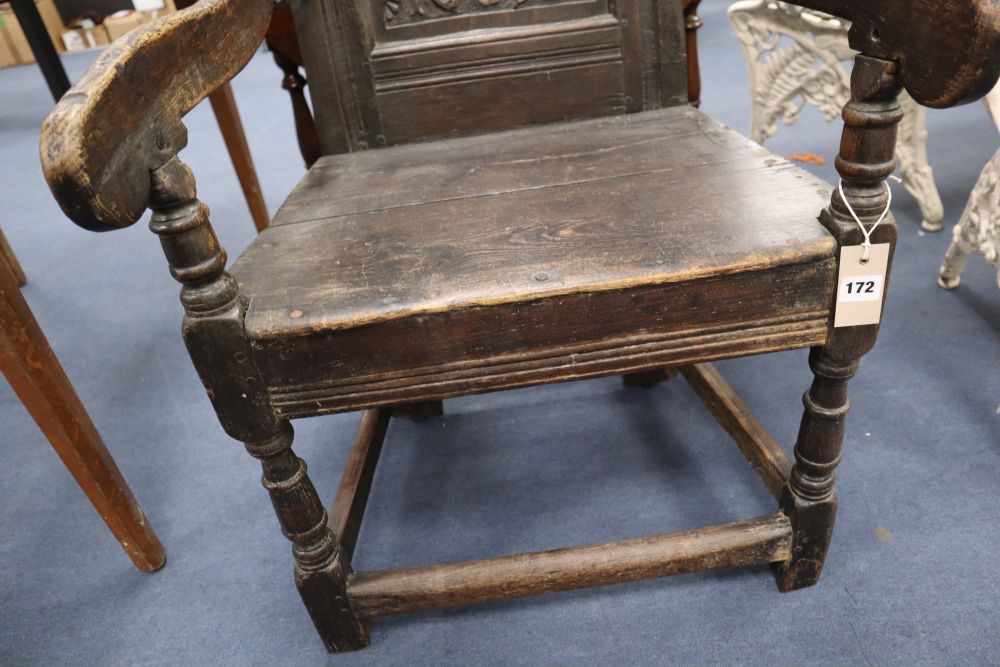 A Charles I oak panel back Wainscot chair, the central panel carved JOHN LUND 1636, some alterations, width 57cm height 111cm